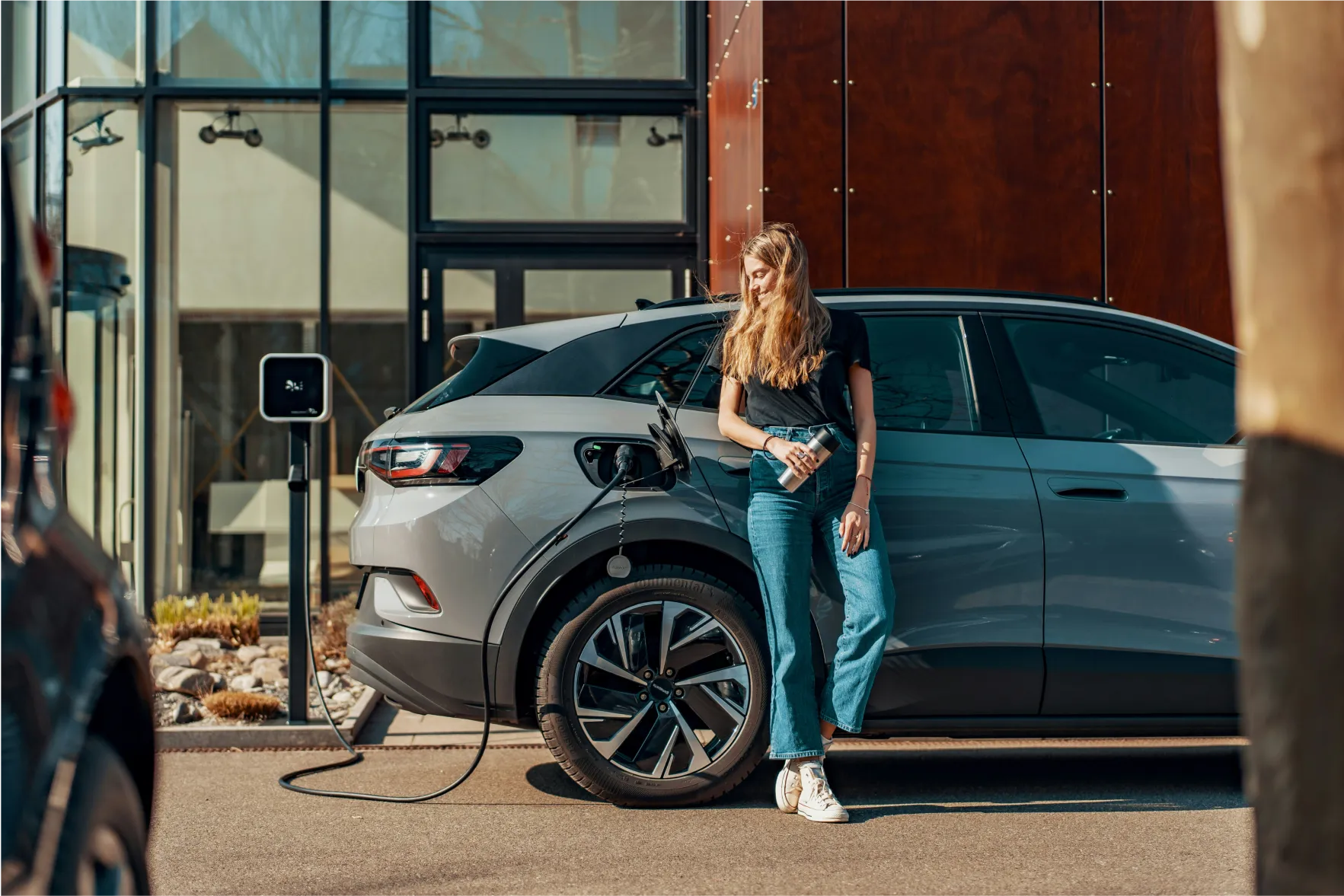 Woman waiting for her car to charge.